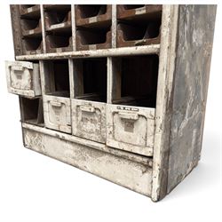F Pollard & Co - late 19th century rustic haberdashery shop cabinet, fitted with an assortment of forty sliding trays, with drawers fitted to base, in antique white-painted finish