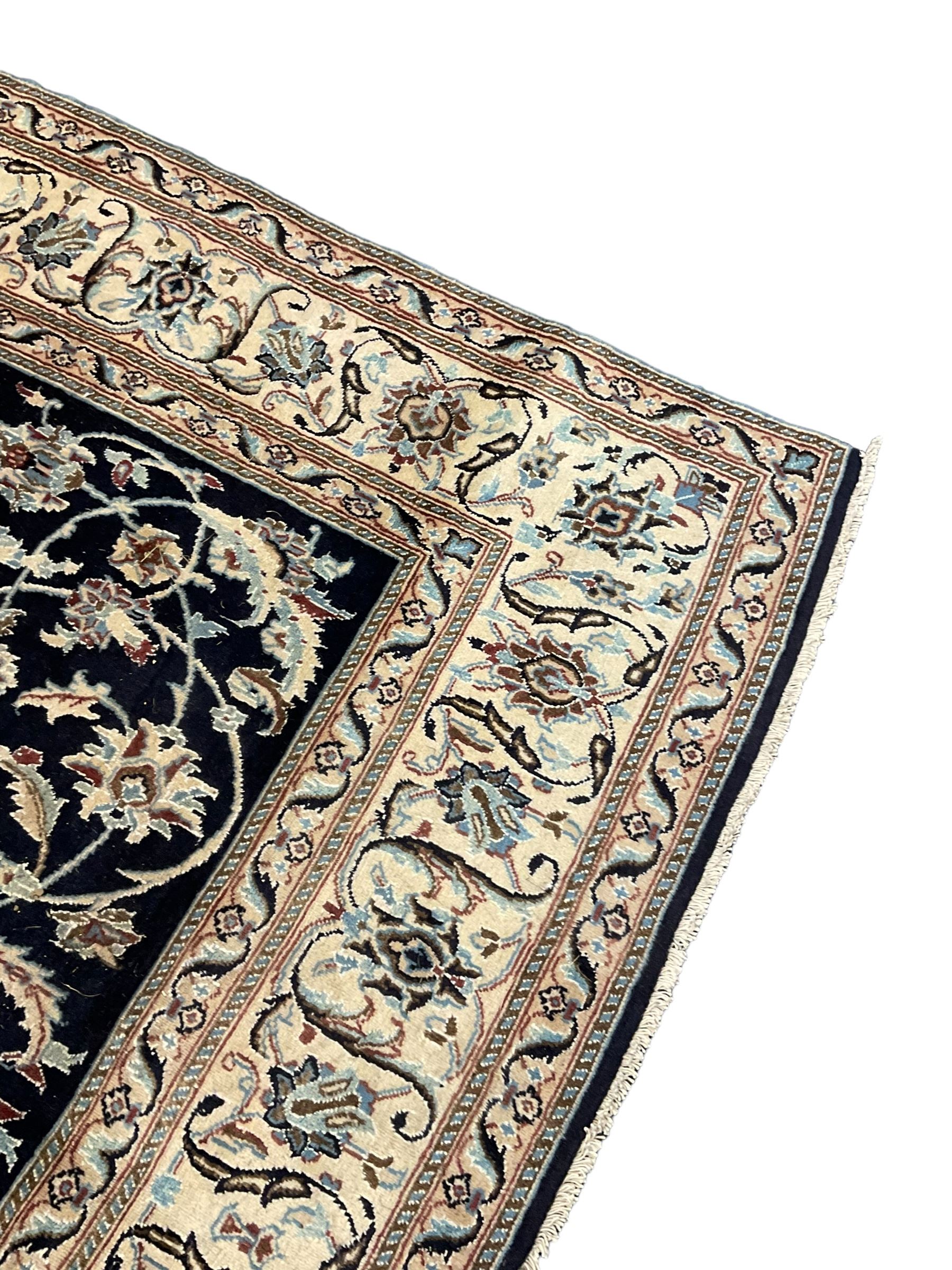 Central Persian part silk indigo ground Nain carpet, the field decorated with interlacing leafy branches and stylised plant motifs, scrolling design border within guard stripes 