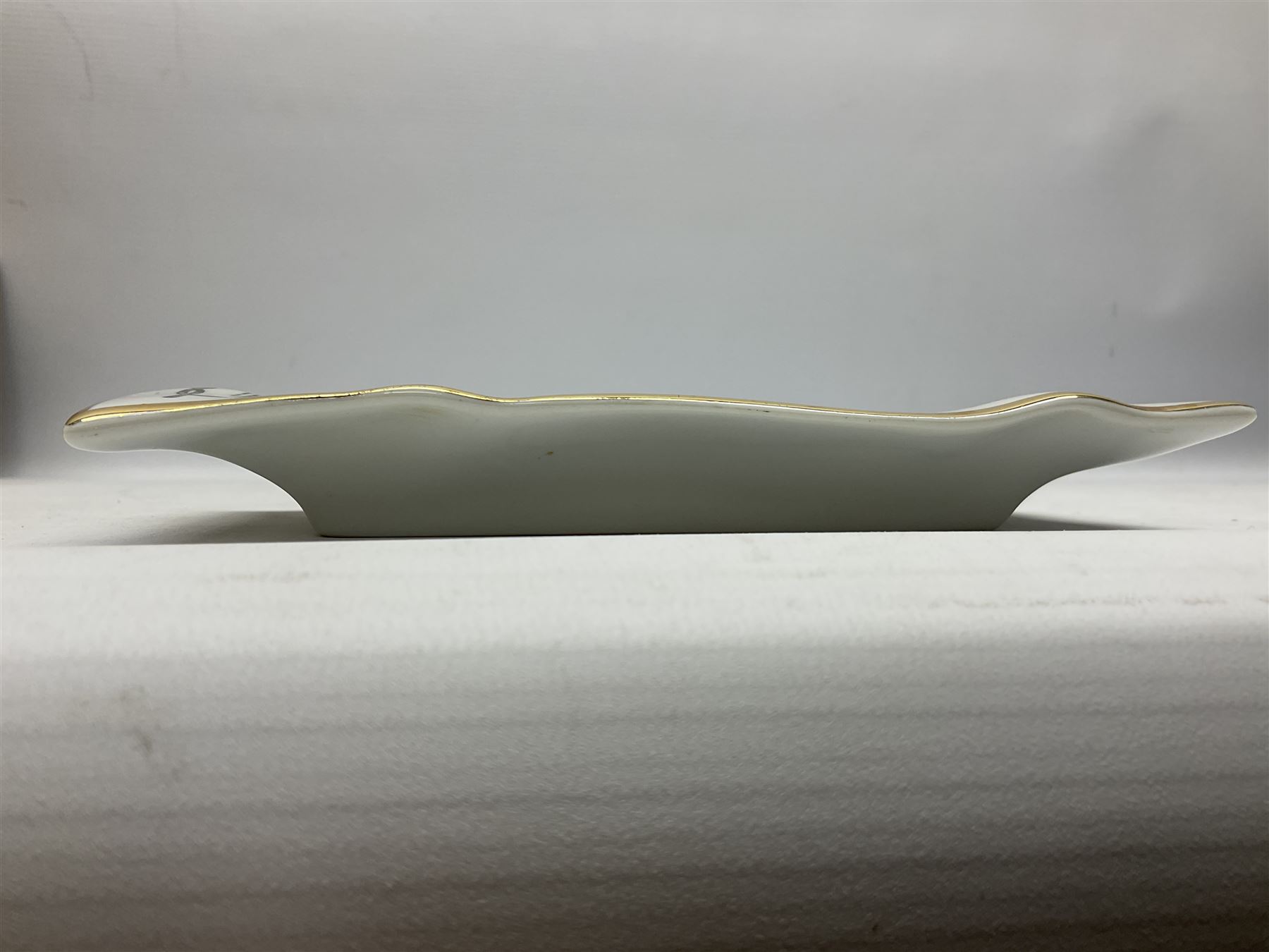 Fornasetti rectangular 'Toscanni's Concert' poster ashtray decorated with black and white text with a gilt border edge, with printed mark beneath, H22cm 