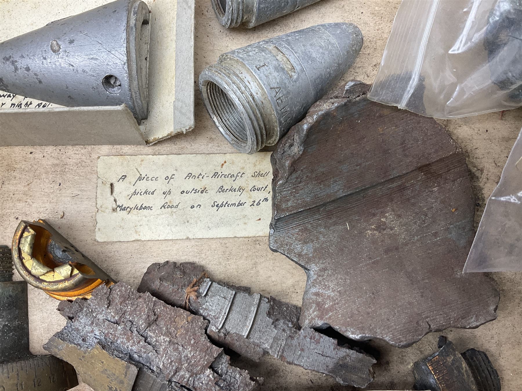 Small collection of WW2 shrapnel and German and British shell parts, most with manuscript details of where and when found including London, Leeds, Bristol, Linton-on-Ouse etc