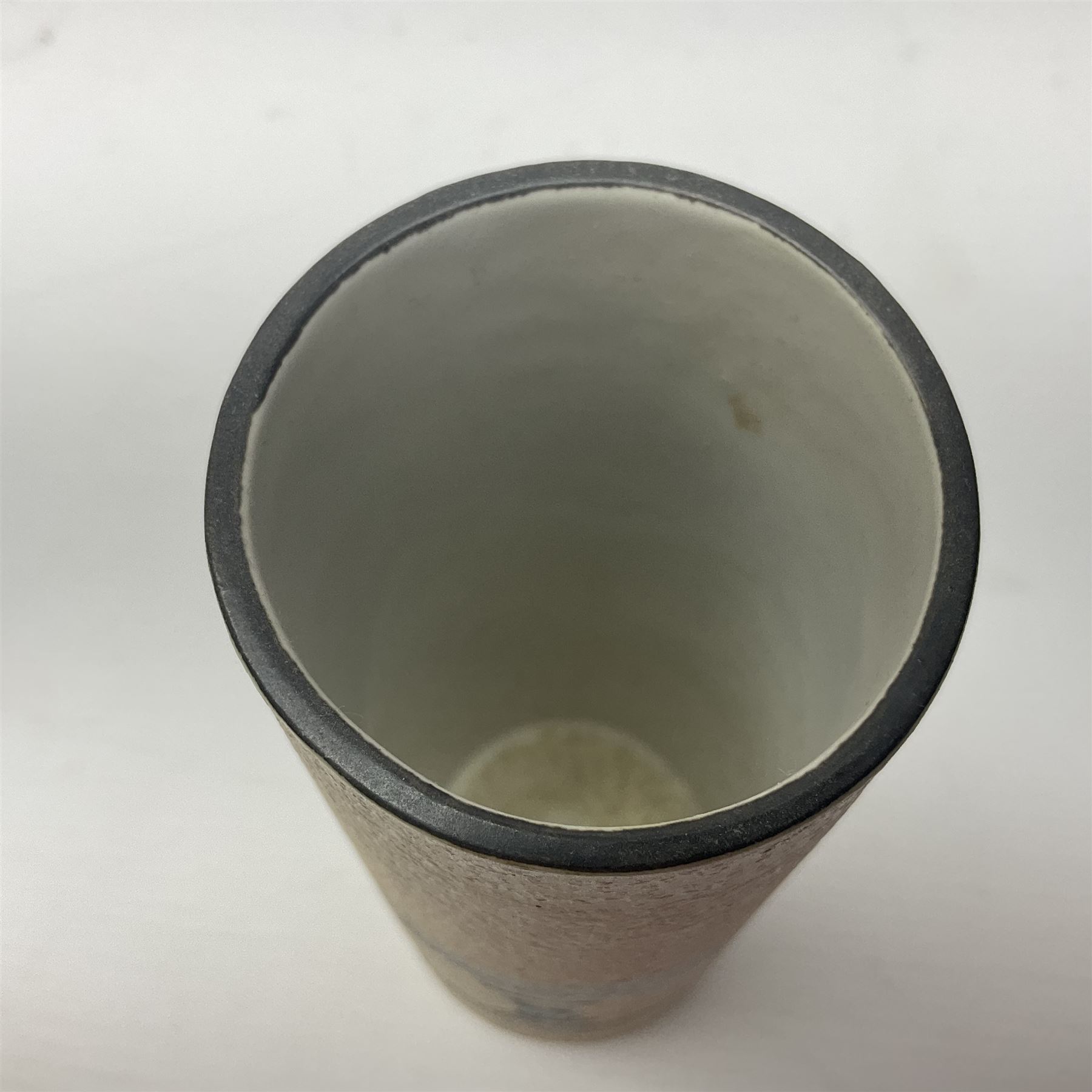 Troika cylindrical vase decorated with circles upon a striped backdrop, designed by Linda Taylor, with painted marks beneath, H14cm