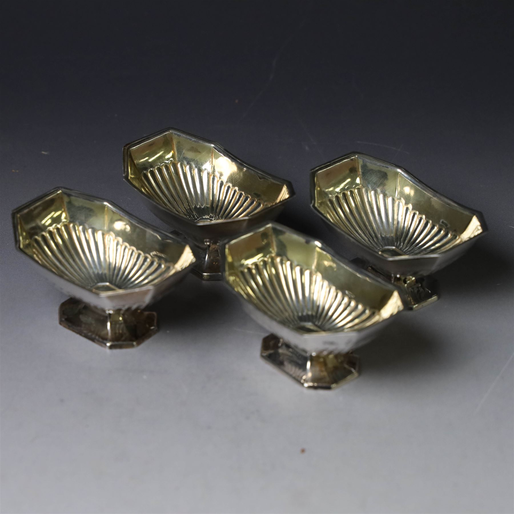 Set of four late Victorian silver open salts, of octagonal part fluted form, with four clam shell spoons, hallmarked Colen Hewer Cheshire, Birmingham 1896, salts H4cm, contained within fitted case