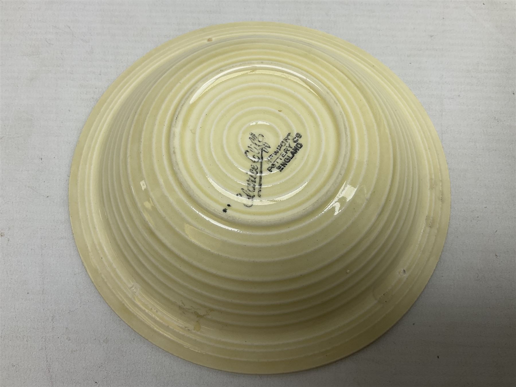 Clarice Cliff for Newport Pottery Corolla pattern tea and dinner wares, comprising triangular bowl, four side plates, two shallow bowls and teacup (a/f), together with a Clarice Cliff Wilkinson twin handled soup bowl and unassociated saucer both decorated with pink and yellow flowers, together with other mid century ceramics comprising Parrott and Company Coronet Ware, and Royal Staffordshire AJ. Wilkinson Ltd dinner wares