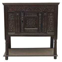 19th century oak cupboard cabinet, the moulded rectangular top above a deeply carved front carved with frieze of lunettes above a central panelled cupboard door with lozenge and foliate carving, flanked by vertical carved panels, upon turned legs with boarded lower shelf