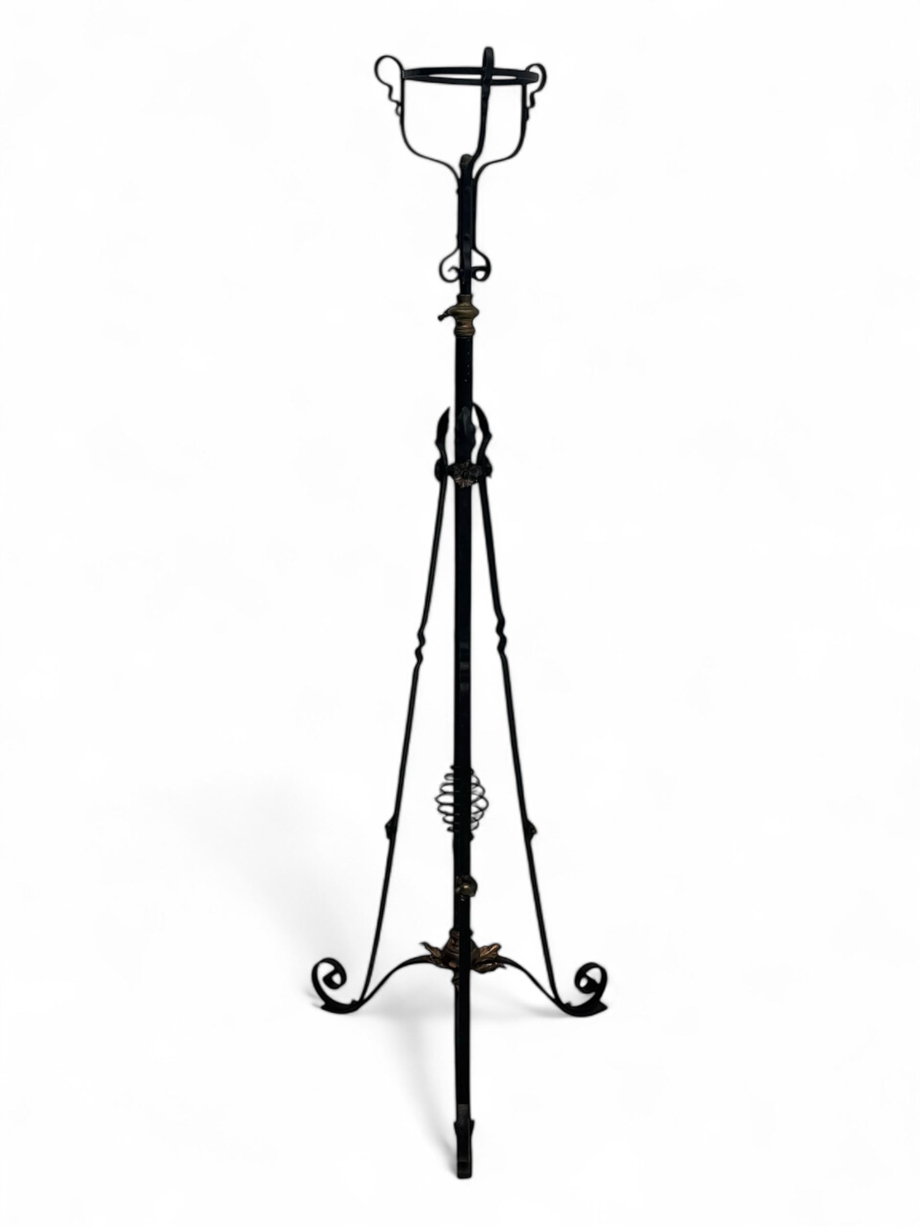 Late 19th century wrought iron and brass pulpit lamp, featuring an adjustable stem with a spiral twist detail, brass foliate mounts, and a tripod base with scrolled feet and decorative floral accents
