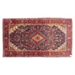North west Persian hand-knotted Sarouk rug, central navy ground field with cusped lozenge ...