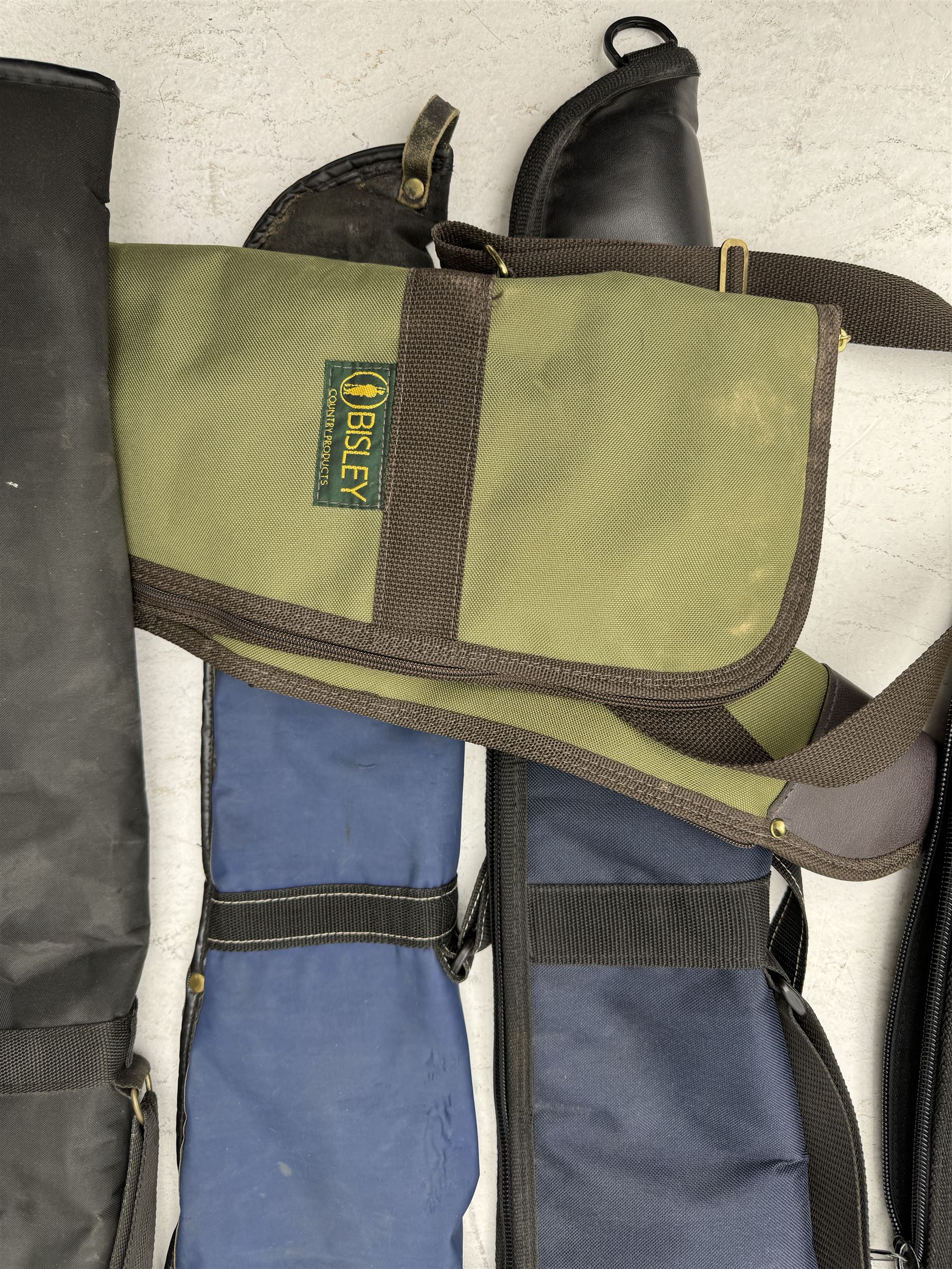 Collection of gun slips, including BSA guns and napier examples and leather 12-bore cartridge belt 