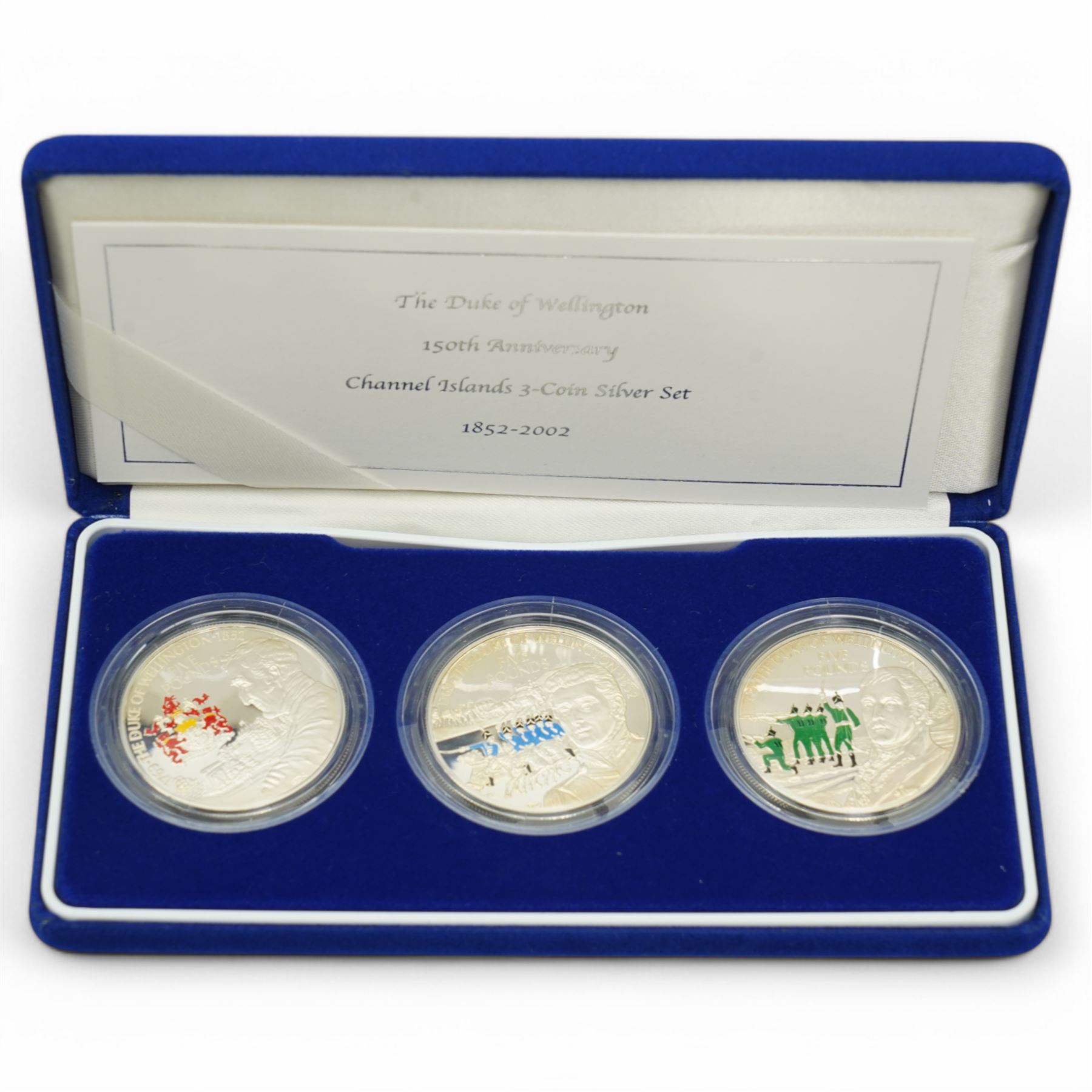 Queen Elizabeth II 'Silver Jubilee' hallmarked sterling silver commemorative stamp ingot, Channel Islands 2002 'The Duke of Wellington' silver three coin set, 2006 'The Queen's Eightieth Birthday Silver Lenticular Medal', Isle of Man 2021 'Silver Proof Sovereign', Danbury Mint 'The 2023 Early Issue Silver Britannia Change-of-Portrait Set', all cased with certificates and a facsimile newspaper etc