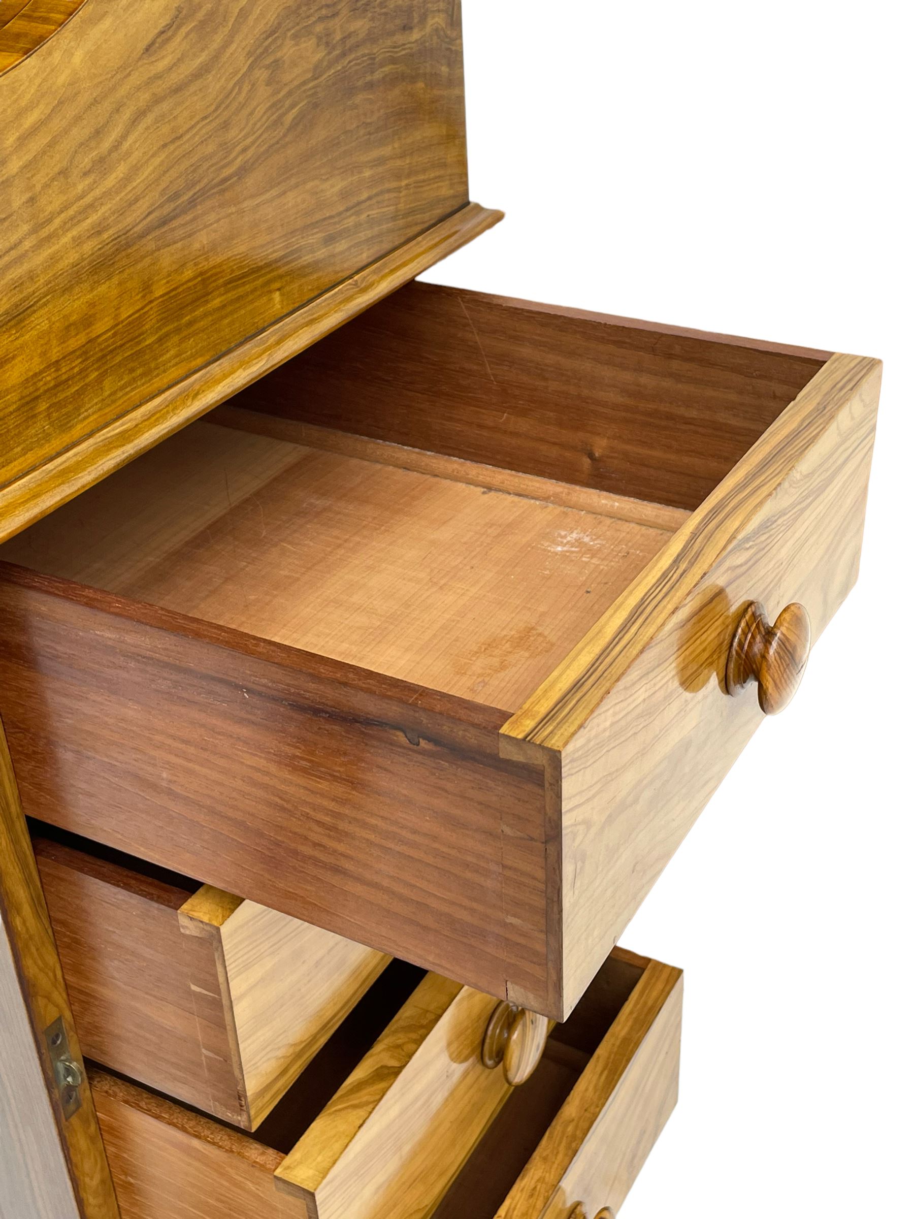 Fine and unusual 19th century olivewood piano top davenport, raised shaped back carved with olive branches and olives, the top hinges to reveal lidded and correspondence compartments, the piano lid enclosing sliding top with hinged and adjustable writing surface with leather inset, right-hand panelled door enclosing four drawers, olive branch and scroll carved cabriole front supports on moulded and shaped platform, turned cup feet with recessed castors 