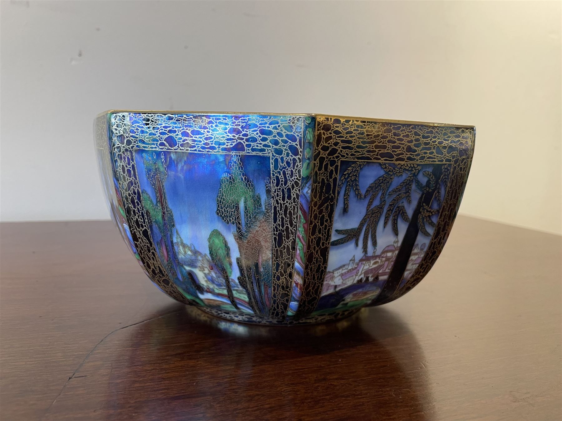 Early 20th century Wedgwood Fairland lustre bowl, circa 1920, of octagonal form, designed by Daisy Makeig-Jones, the exterior decorated in the Castle on the Road pattern, the interior decorated in the Fairy in a Cage pattern, pattern no Z5125, with printed marks beneath, H11cm D22.5cm
