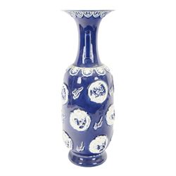 Chinses twin handled blue and white vase, decorated in relief with dragons amongst clouds upon a blue ground, H58cm 