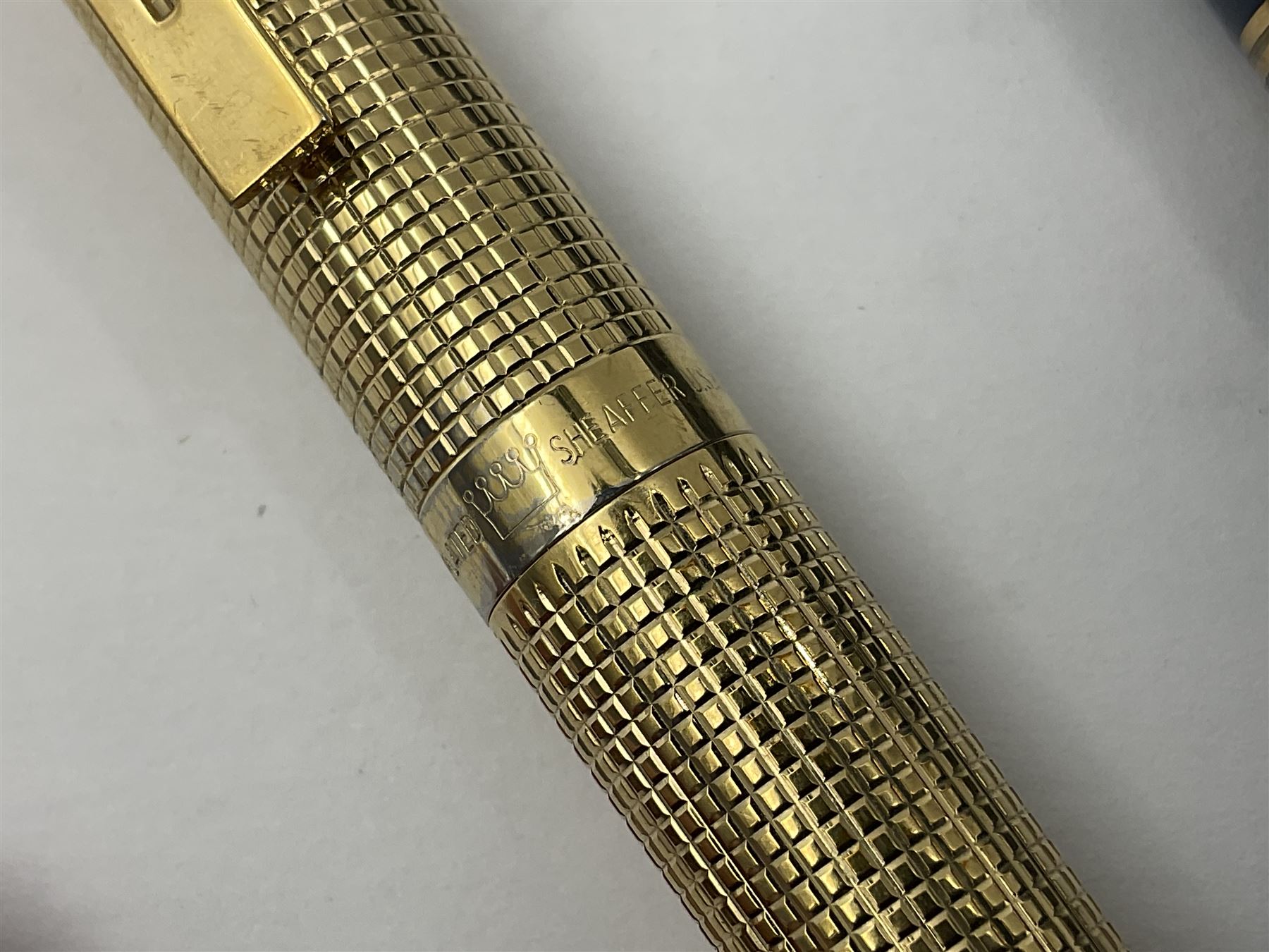 Sheaffer Targa 1011 Diamond Square fountain pen, the gold plated barrel with nib stamped 14K 585, together with another Sheaffer Targa fountain pen with blue barrel and gold nib stamped 14K 585 and matching ballpoint, and Sheaffer ballpoint pen with sterling silver barrel, largest L13.5cm (4)