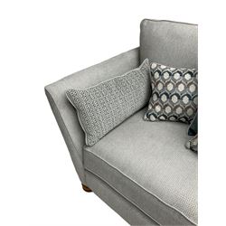 Oak Furnitureland - 'Gainsborough' lounge suite - three seat sofa, out-swept arms with loose cushions on turned oak feet, upholstered in 'Minerva Silver' fabric (W209cm D102cm H80cm); matching armchair or snuggler settee (W125cm); and rectangular ottoman footstool