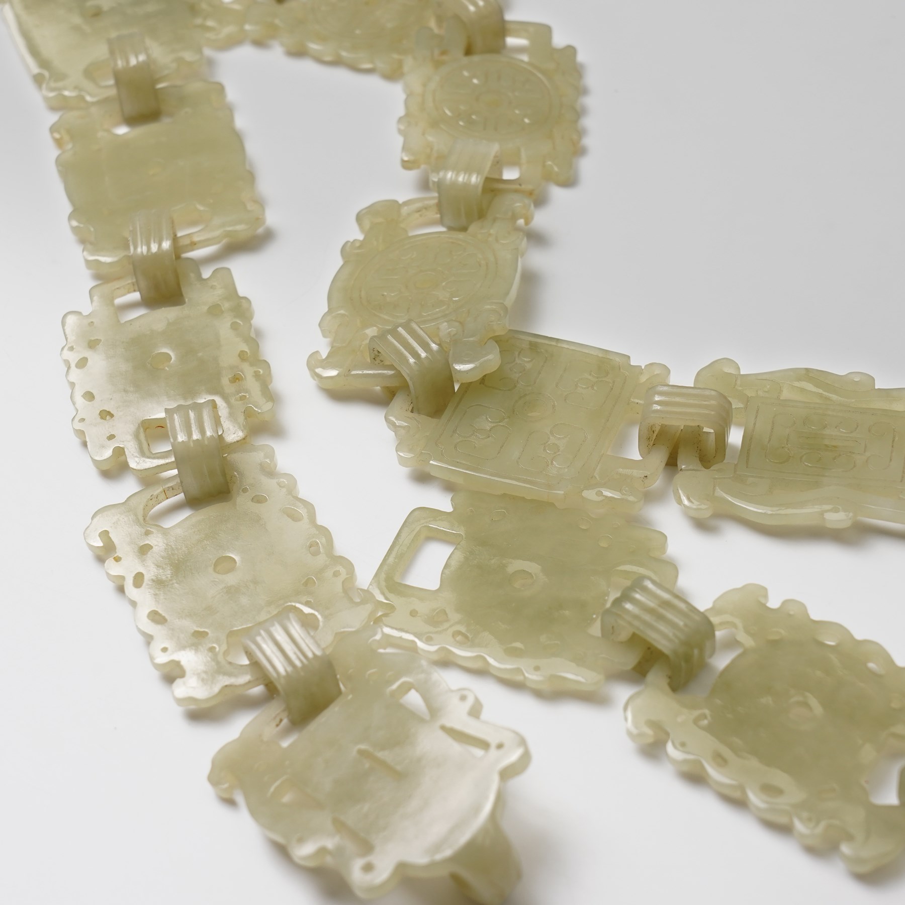 Chinese carved greenstone belt, each link carved with symbols, W108cm 