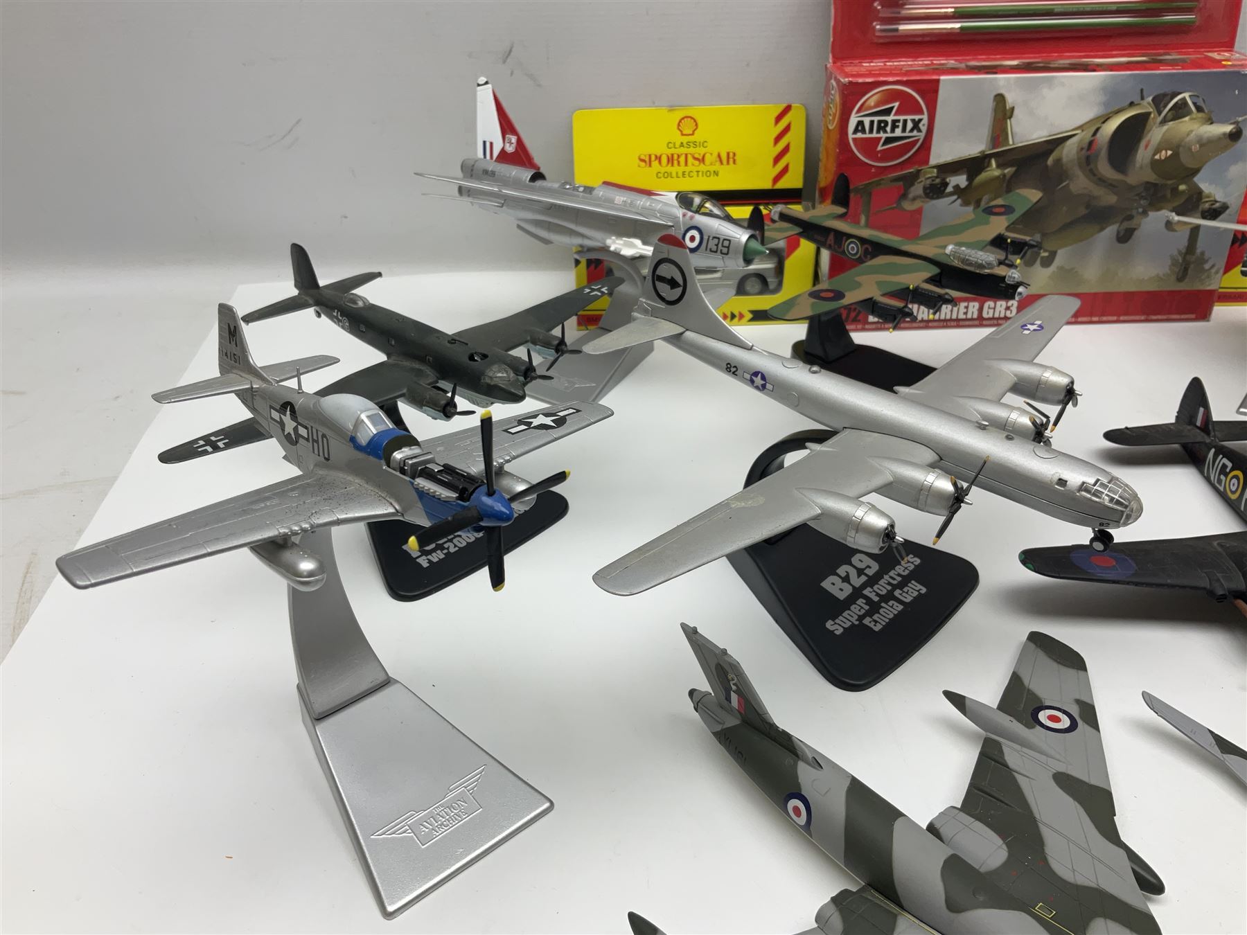 Thirteen unboxed Corgi Aviation Archive or similar die-cast models of aircraft, most with stands; Airfix 1:72 scale construction kit for BAe Harrier GR3; and two boxed Shell Collection die-cast models of cars
