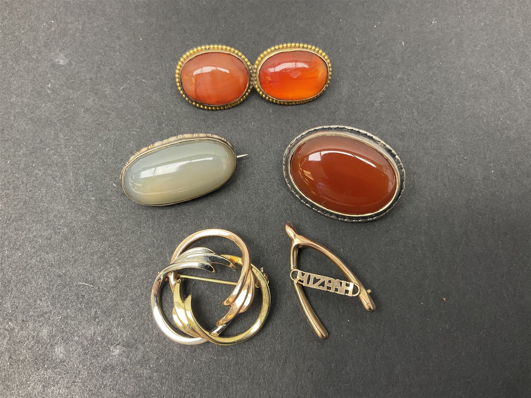 9ct gold jewellery including leaf brooch, wishbone Mizpah brooch, carnelian brooch, gold cased ladies Omega wristwatch, on leather strap and gold cased ladies Tissot wristwatch on expanding gilt strap, together with silver brooches and a Czech paste buckle, etc