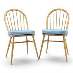 Ercol - pair of 'Windsor' dining chairs, with high hooped back, blue seat cushions with st...