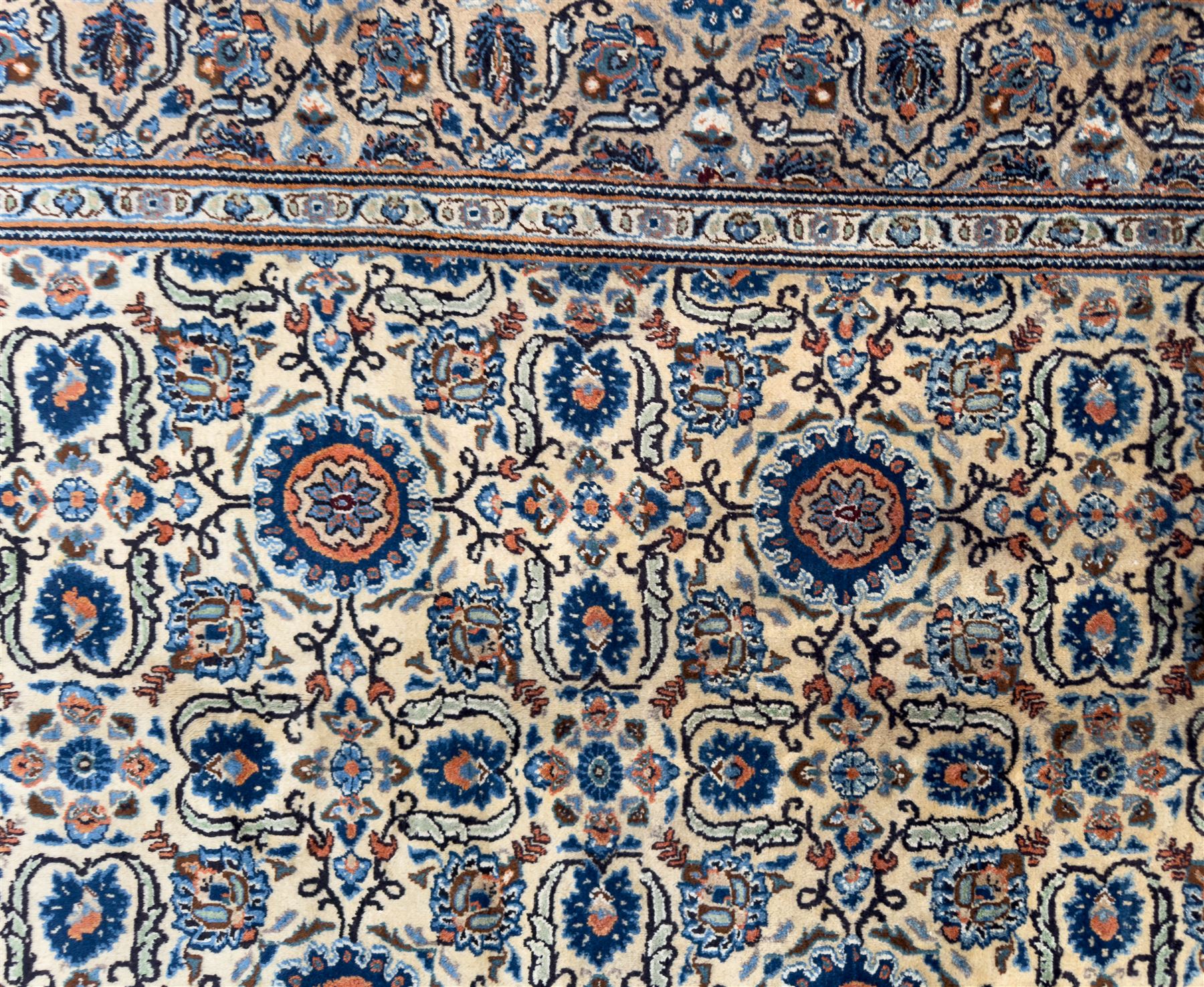 Northwestern Persian Tabriz hand-knotted carpet, the ivory ground with an all-over repeating Herati pattern of stylised palmettes, rosettes and serrated leaves in shades of indigo, terracotta and sky blue, framed by a dark blue border of arabesque vines and scrolling foliage between floral guard stripes, from the region of Tabriz