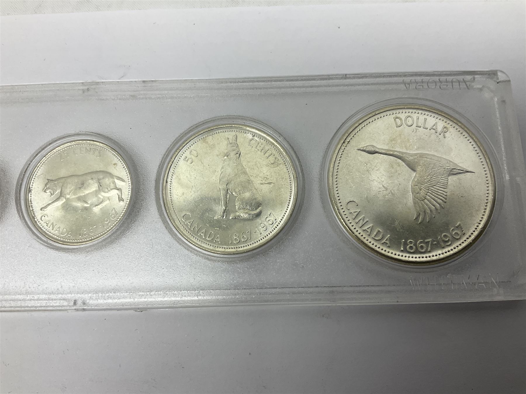 South Africa 1897 one shilling, 1967 one rand, Ireland 1928 two shillings and sixpence, Netherlands 1930 two and a half gulden, two Queen Elizabeth II Canada one dollar coins dated 1958 and 1964, 1967 six coin set in plastic holder etc