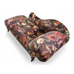 Victorian hardwood-framed chaise longue, serpentine back with rolled arm, upholstered in floral pattern fabric, on ring turned legs with ceramic castors 