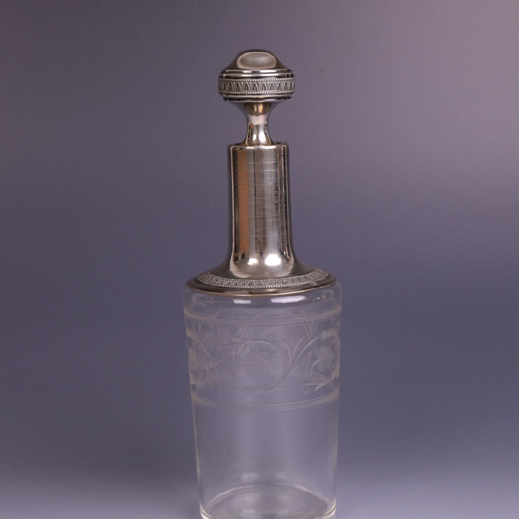 French silver mounted glass decanter and shot glass set, the decanter with silver covered stopper, removable silver collar, and etched decoration to glass body, the six silver mounted glasses each with etched decoration, silver stamped with Minerva's head, decanter H 21cm
