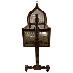 Victorian mahogany rocking crib, cane-work canape hood and sides, raised on turned und supports united by stretchers