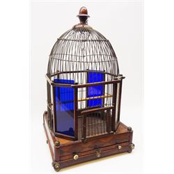 George III bird cage, the mahogany and rosewood base with geometric inlay, brass ball feet, conforming brass ball knops and ivory handles to the sliding floor, supporting a domed wirework cage with two frosted and two blue glass panels, and turned acorn finial, H54cm 