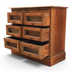 20th century Haberdashery style hardwood chest, two brushing slides, with six glass fronted drawers, blackened metal pulls, plinth base 