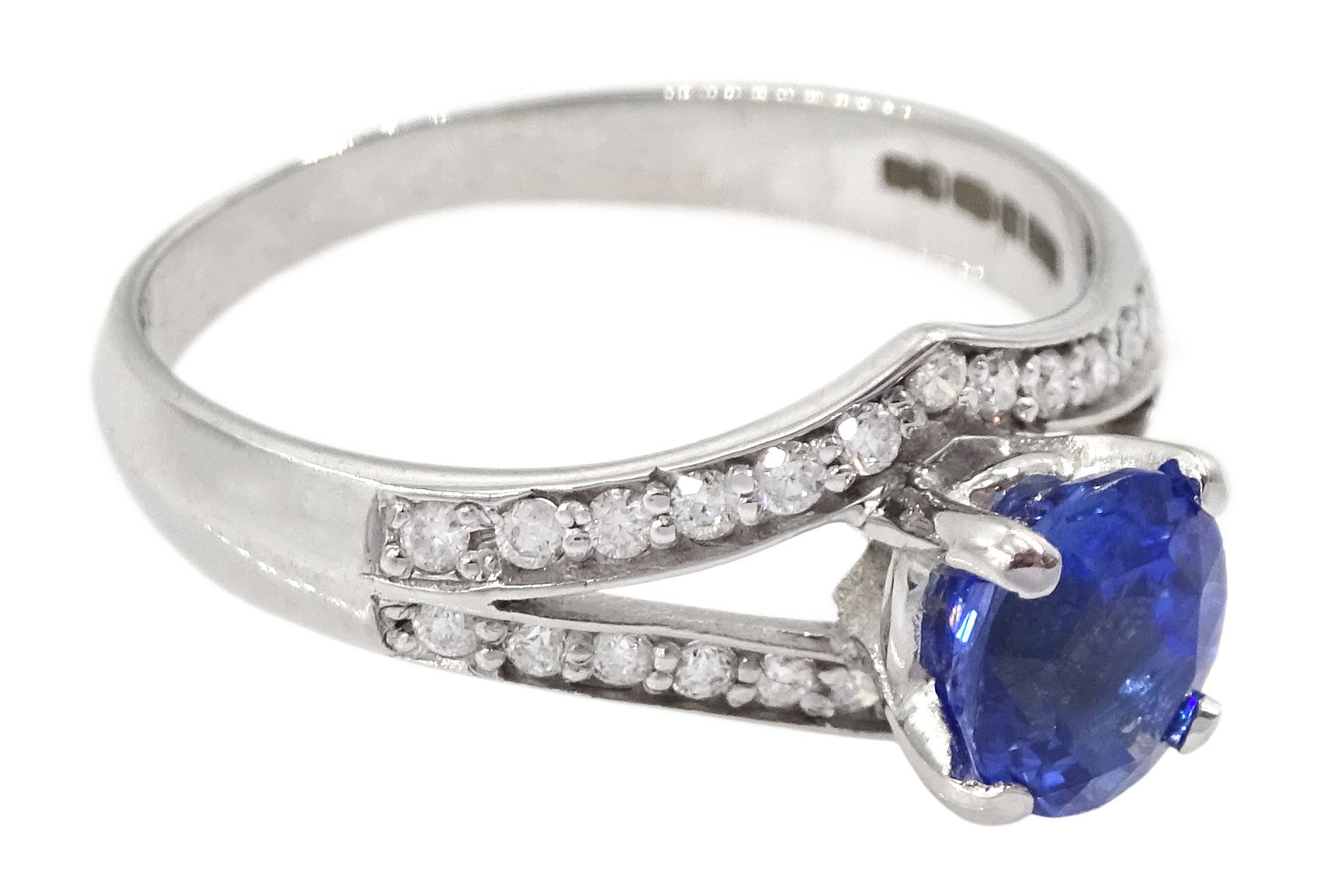 White gold sapphire and diamond ring, single oval cut sapphire of approx 1.00 carat, with split design diamond set shoulders, hallmarked 14ct