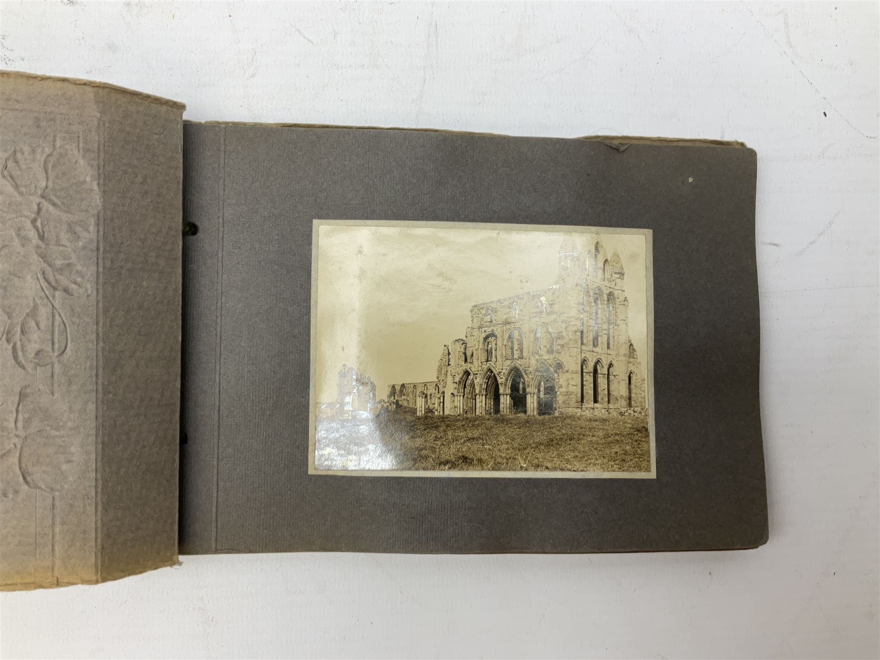 Quantity of books and postcards predominantly of Whitby interest including Hornes' Guide to Whitby 1890 and Hornes' Tourist map of Whitby, A Holiday Tour in and Around Whitby by H.S. Forman 1896 etc