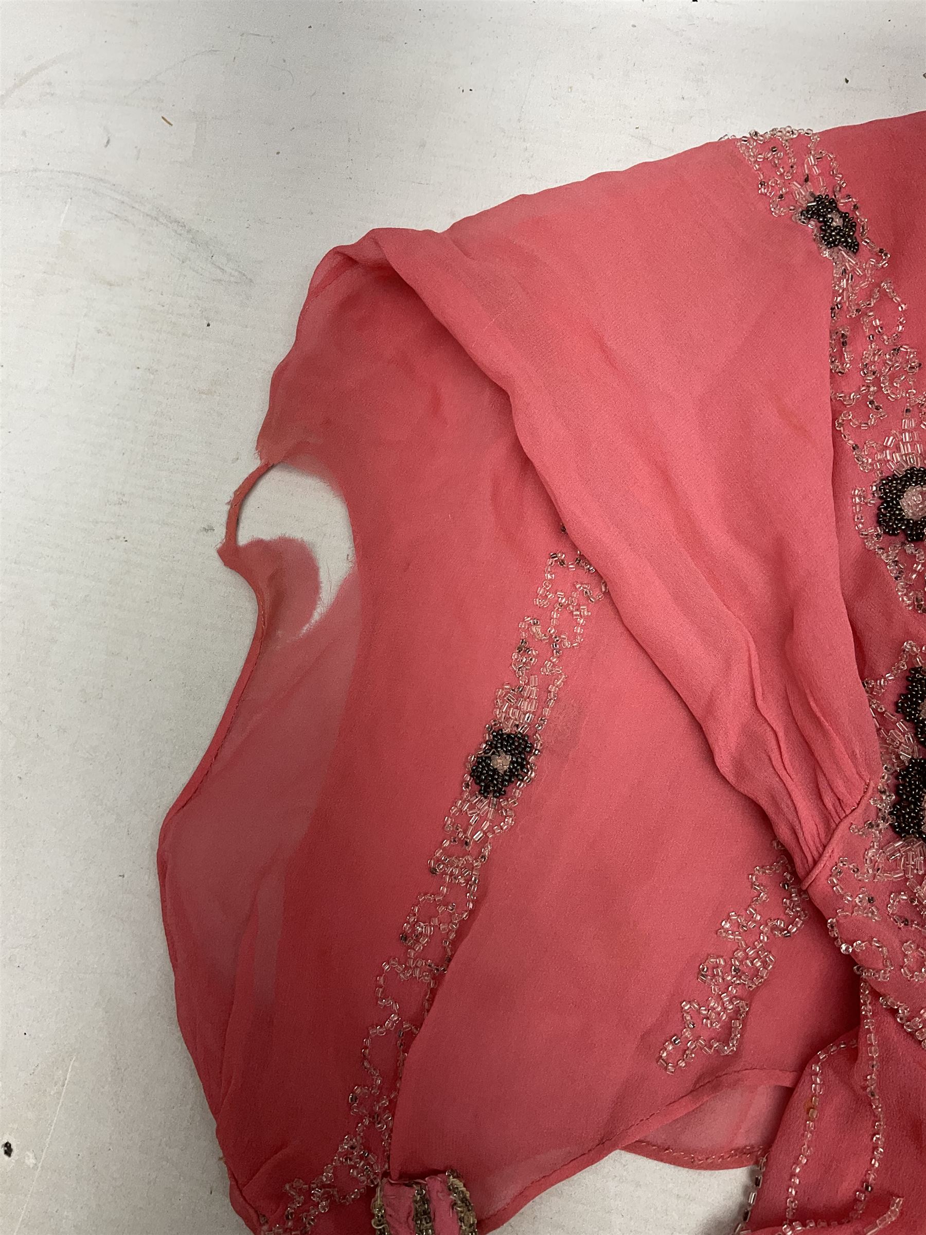 Art Deco pink flapper type beaded dress, with floral motifs and tasselled clear and black beadwork throughout