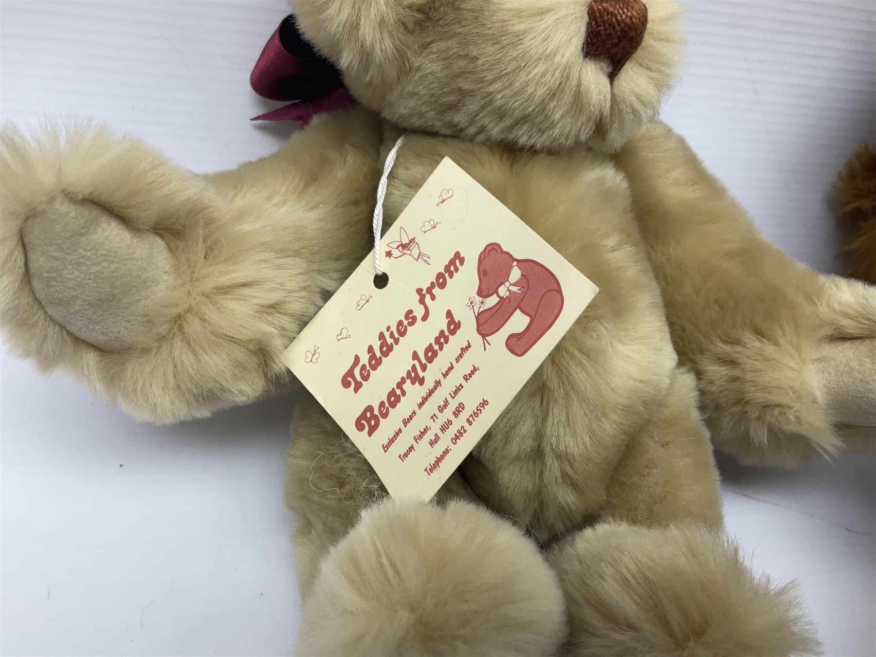 Group of five teddy bears comprising ‘George’ a unique pellet filled bear with glass eyes and velvet paws H38cm, and ‘Abbey’ a luxury German plush with wobble head and glass eyes no.5/10 H24cm, both with Teddies from Bearyland labels; along with two light blonde mohair H. M. Bears and Boyds Bears ‘T. F. Wuzzies’ no. 595140 (5)
