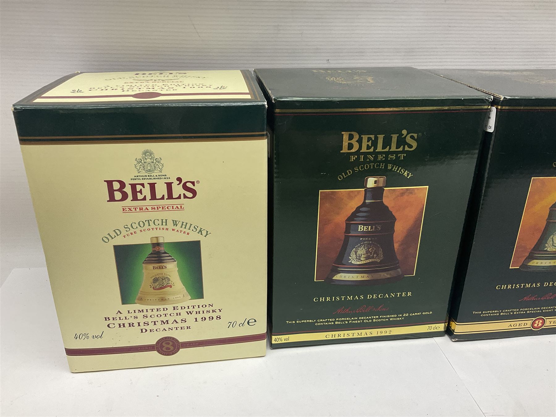 Dimple 15 Year Old Blended Scotch Whisky, together with nine Bells, scotch whisky, in Wade ceramic decanters, including Christmas 1991, 1998, 1996 etc, of various contents and proof 