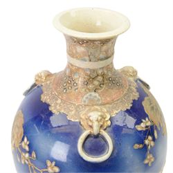 Japanese Satsuma vase, of ovoid form with wasted neck, and three applied mask mounted ring handles, upon four mask detailed feet, the blue ground body painted with blossoming vines, with painted gilt mark beneath, H38cm