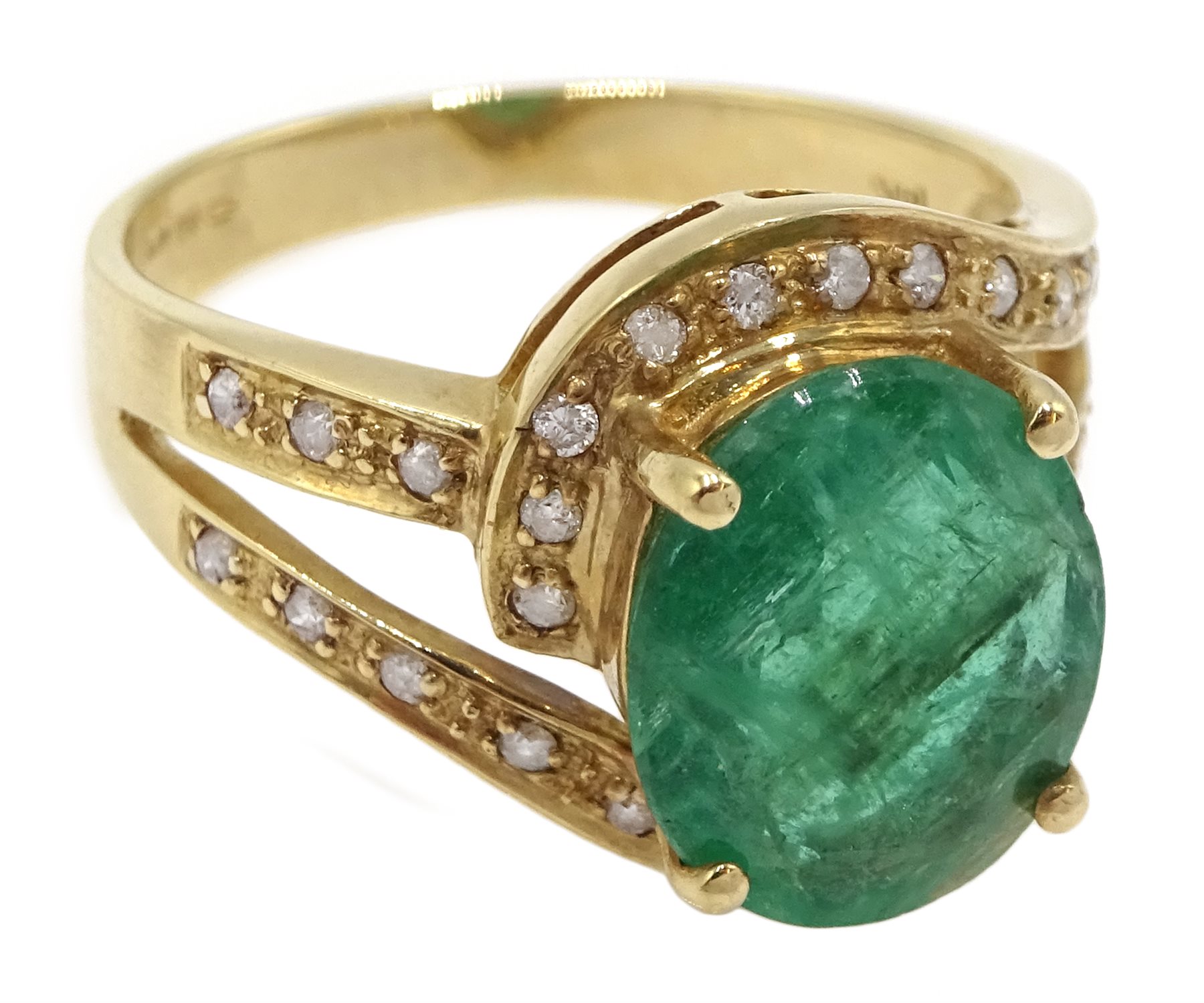 Gold oval emerald ring with diamond swirl surround and shank, stamped 14K