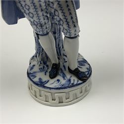 Meissen blue and white figure, modelled as a gentleman holding a hat of flowers, raised upon Greek key design base, with blue crossed swords and impressed C 73 and 149 marks beneath, H18cm