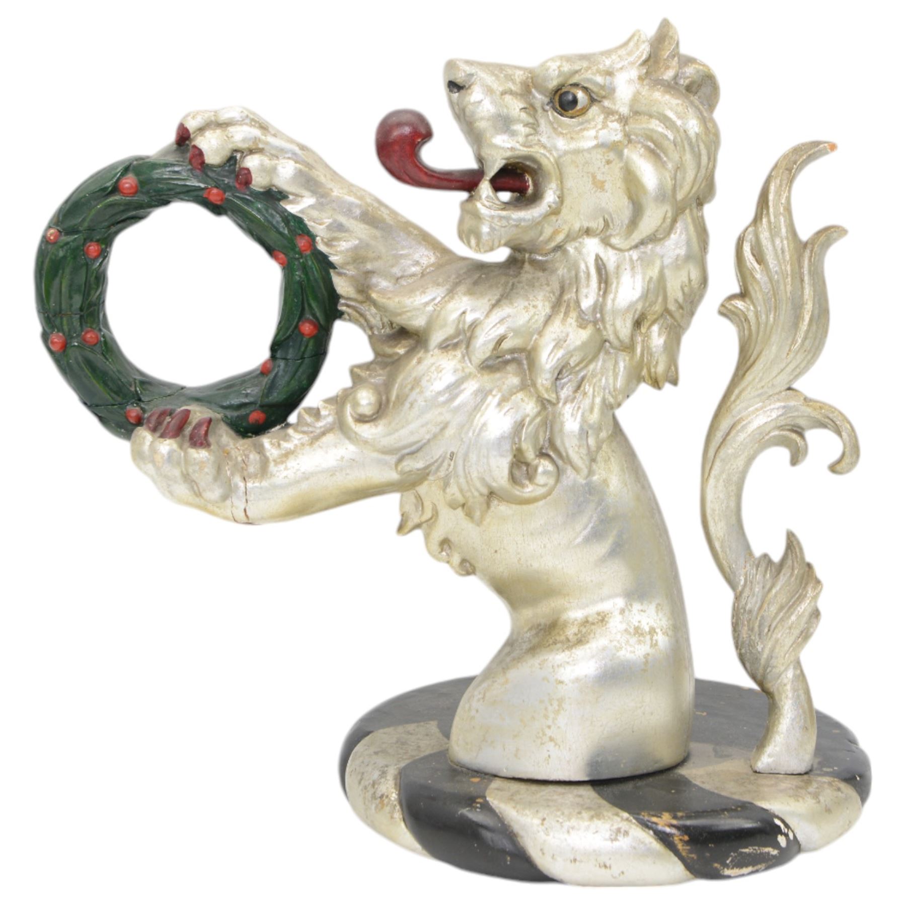 20th century carved silvered wood crest of a lion holding a wreath, possibly a horse tether, on circular wooden plinth, H37cm 