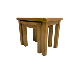 Light oak nest of two tables, rectangular top raised on square supports