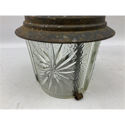 Wrought iron wall lantern with patterned glass shade of tapering cylindrical form, H29cm
