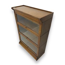 Early 20th century oak three-tier stacking library bookcase, enclosed by hinged and sliding glazed doors