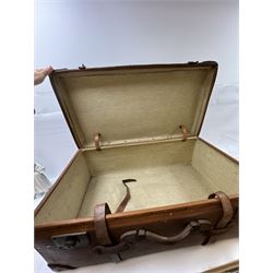 Early 20th century leather trunk, with brass fixtures, leather straps and buckle fastenings, embossed to the top with initials GG, H28cm, W76cm