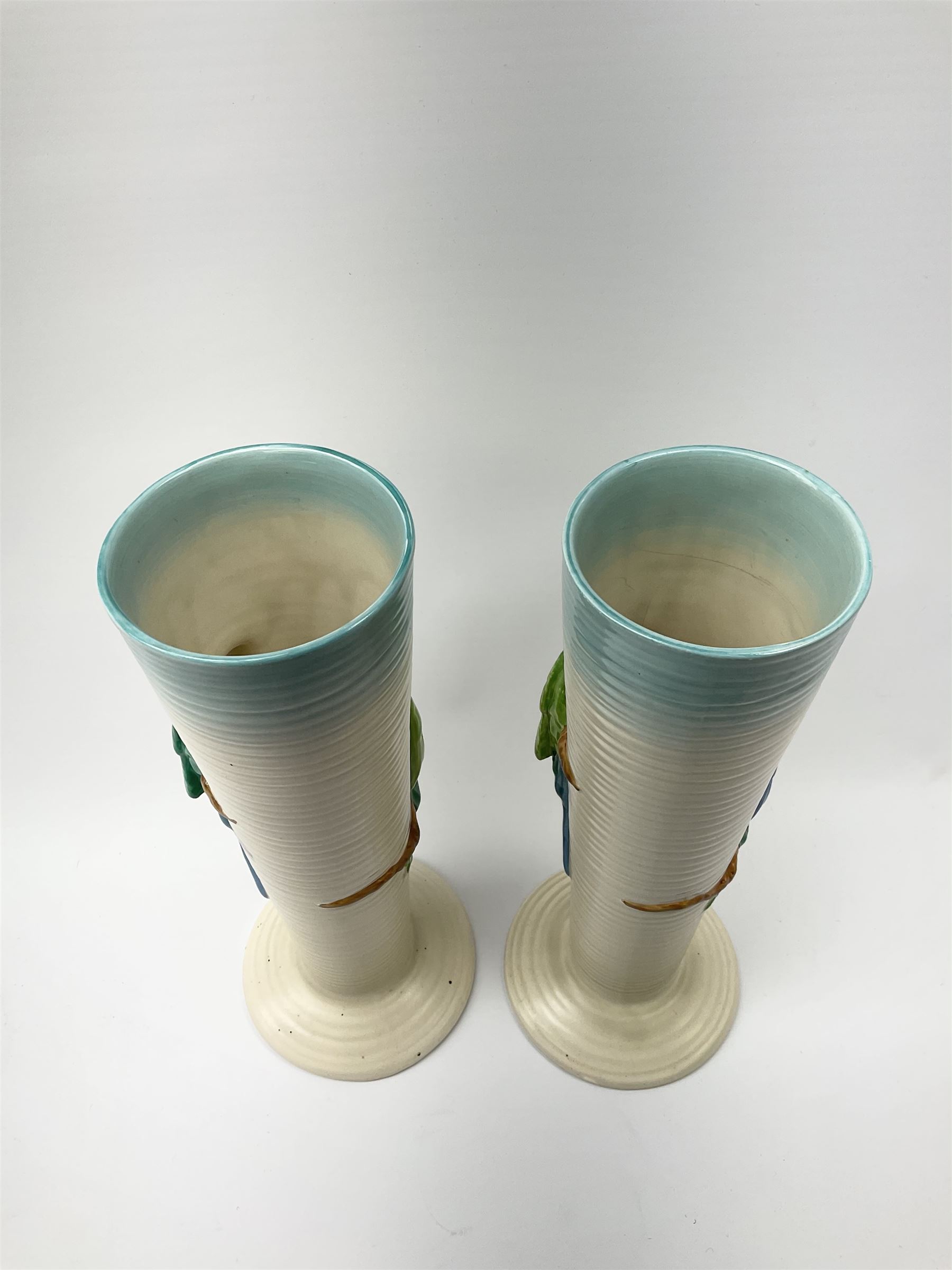 A pair of Clarice Cliff Newport Pottery vases, of tall ribbed conical