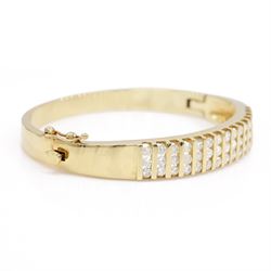 14ct gold diamond hinged bangle, fifteen rows each channel set with three round brilliant cut diamonds, stamped 14K, total diamond weight approx 3.15 carat