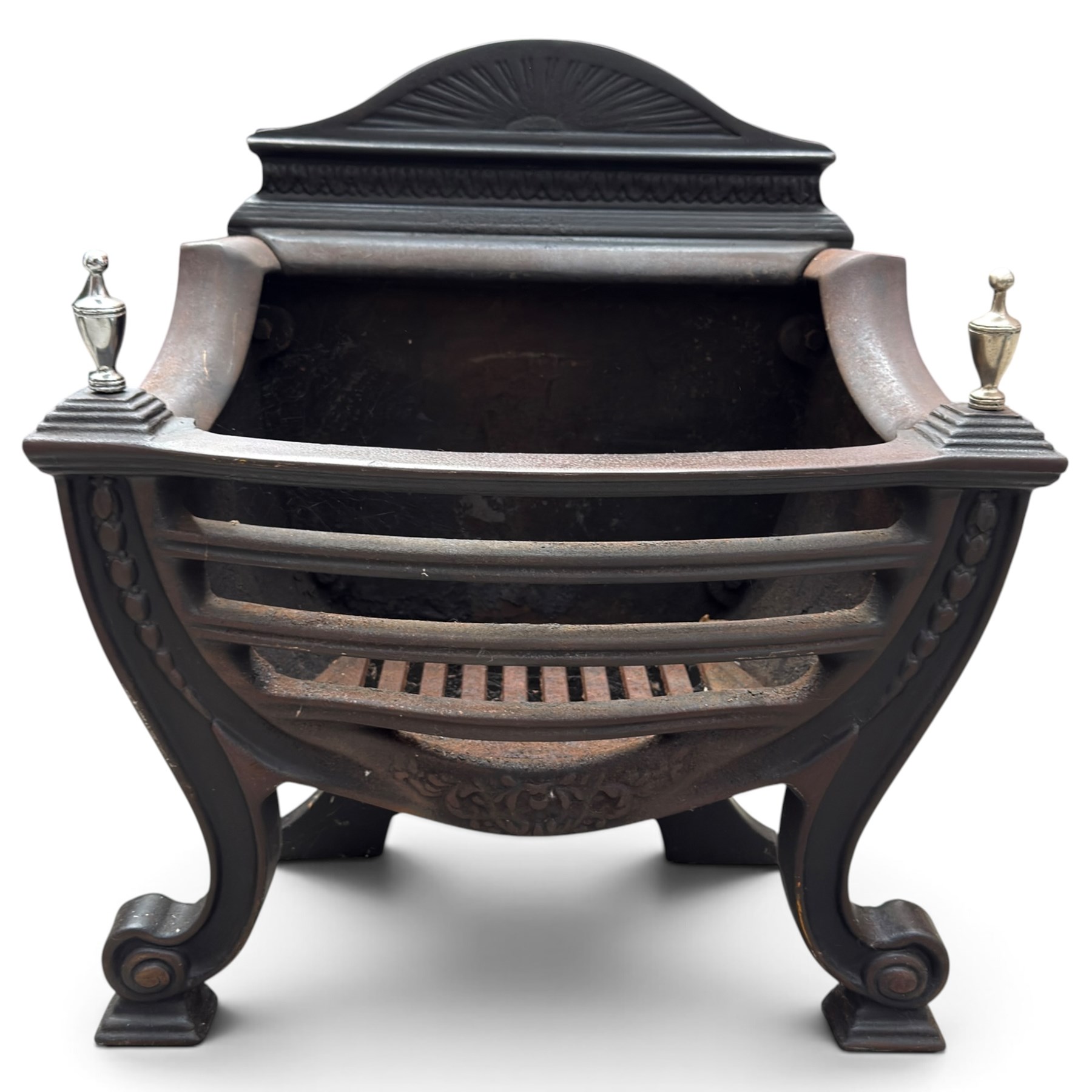 Three cast iron fireplace fittings, comprising a Regency-style fire grate with sunburst crest, urn finials, bowed basket and scroll supports (W58cm H63cm); Victorian fender with pierced acanthus frieze and foliate base (W64cm H20cm); Gothic Revival fireplace with fleur-de-lis crest, arched surround and integral fire basket (W41cm H87cm)