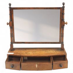 19th century mahogany swing mirror, rectangular frame on turned supports with ball finials, bow front base fitted with three drawers and ebony knob handles, raised on shaped feet