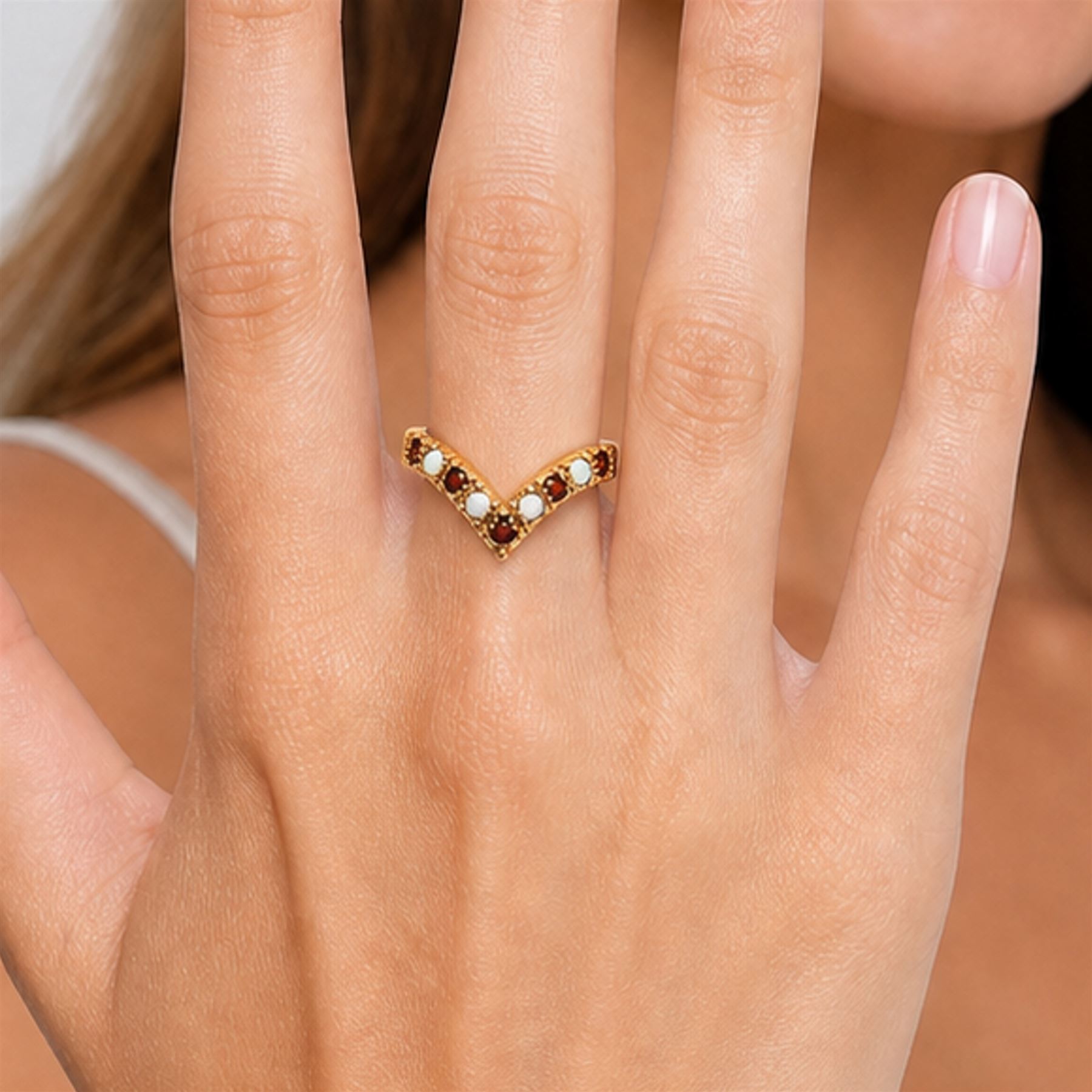 9ct gold garnet and opal wishbone ring, set with alternate round cut garnets and cabochon cut opals, London 1980