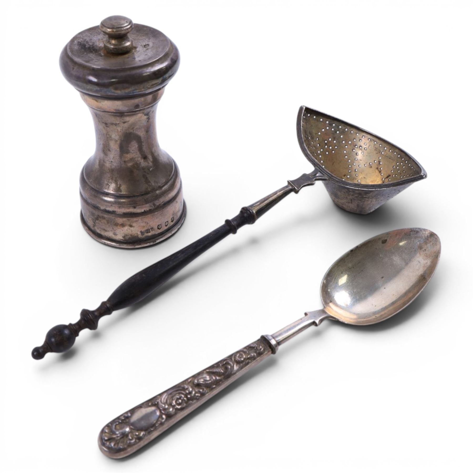Silver pepper grinder, sifting ladle, silver handled spoon and eight silver napkin rings, all stamped or hallmarked