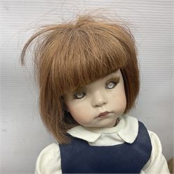 Mid-20th century woodwool filled teddy bear; and porcelain doll dressed as a WW2 evacuee