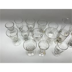 A group of Victorian drinking glasses, comprising mostly rummers, many with part slice cut bowls. 
