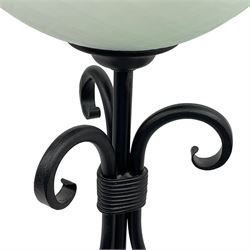 Pair of black finish wrought metal standard lamps with glass shades 